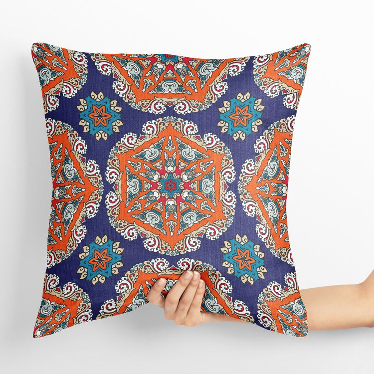 Blue cushion cover with ornate orange and turquoise floral medallions.