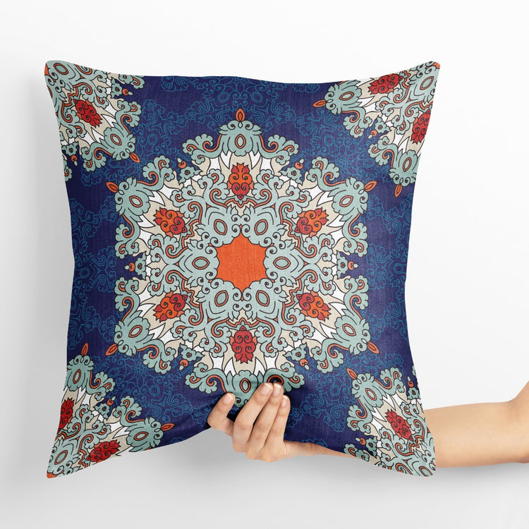 Navy cushion cover with a large pale blue and orange ornamental medallion.