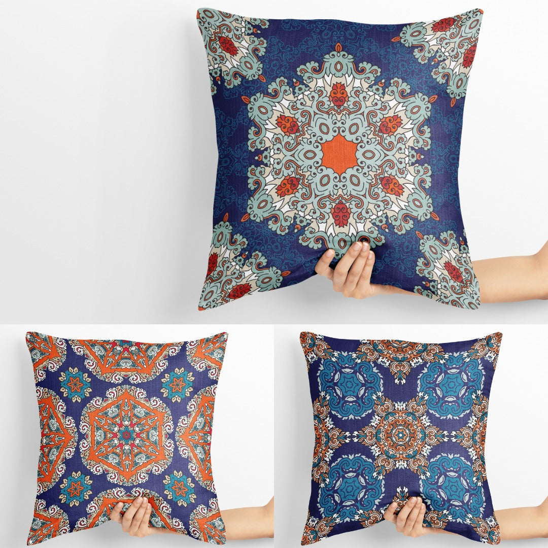 Three blue cushion covers with ornate multicoloured floral medallions.