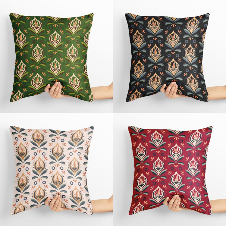 Four cushion covers with repeating cream and gold coloured botanical motifs on different backgrounds.