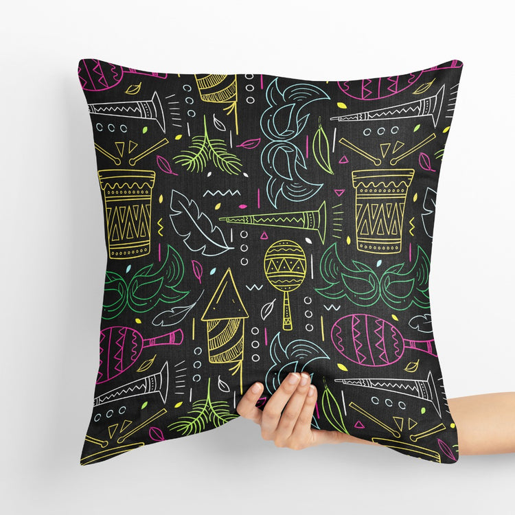 Black cushion cover with fine green, yellow and purple festival-themed drawings.