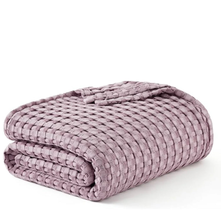Folded lilac waffle-weave blanket on a white background.