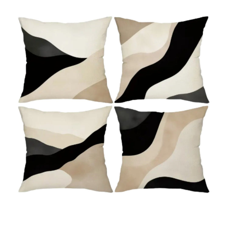 Four cushion covers with sweeping black, beige and cream abstract shapes.