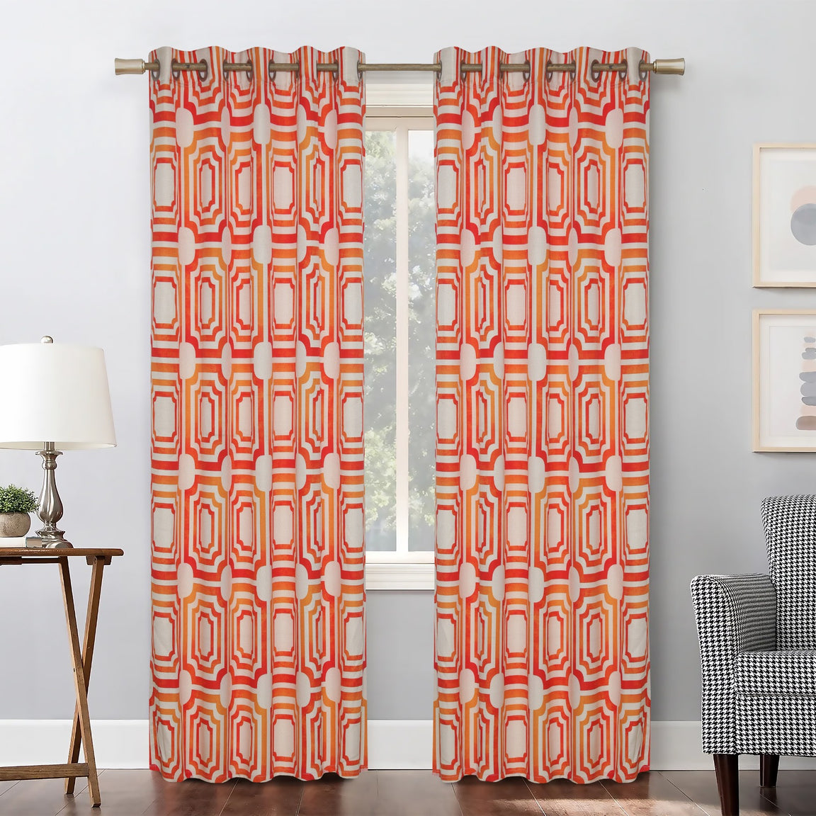 Orange and cream geometric eyelet curtains hanging at a window.
