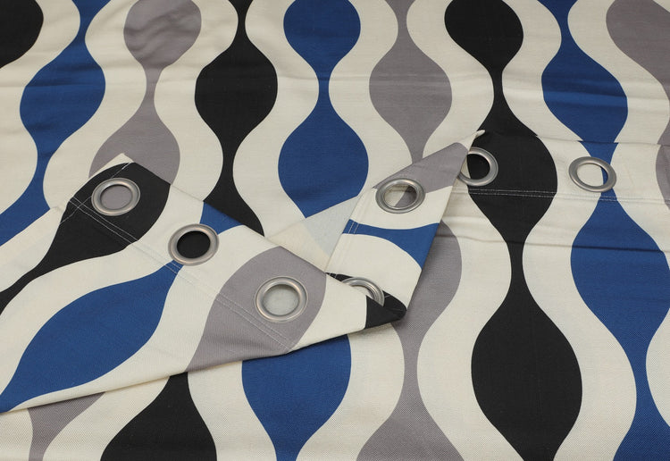 Close-up of blue and black wavy curtain fabric and metal eyelets.