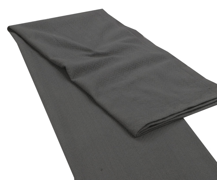 Charcoal grey throw laid out with its folded edge visible.