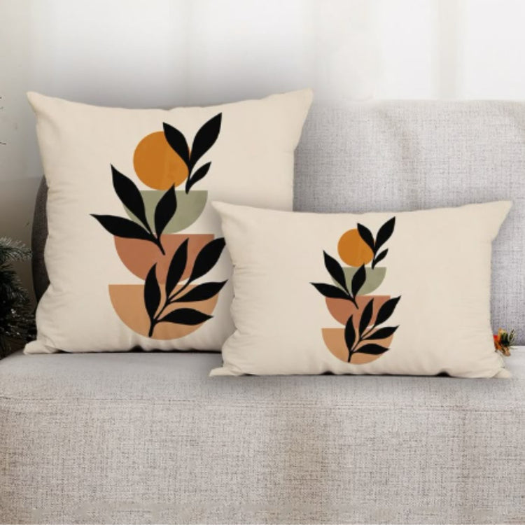 Square and rectangular cream cushion covers with black leaves and mustard and rust circles.