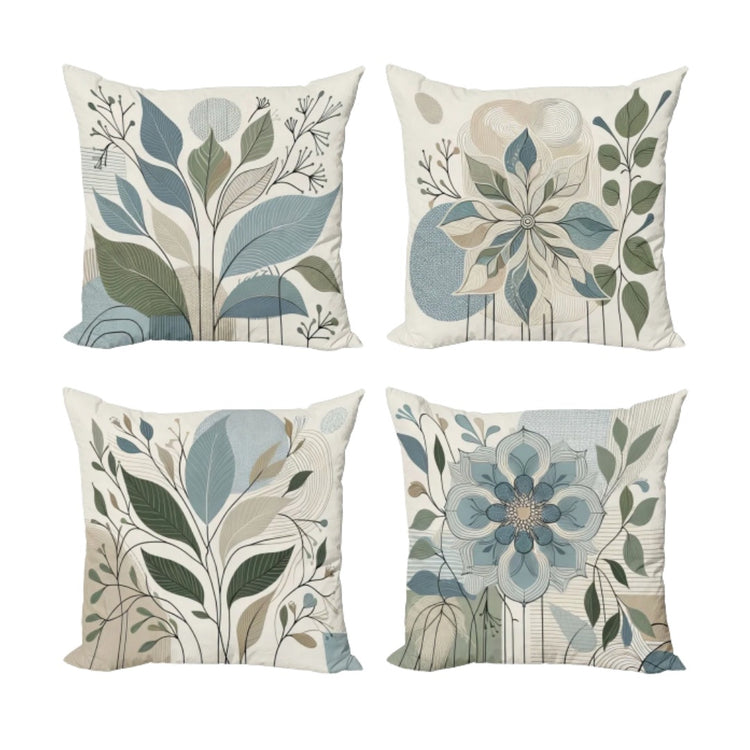 Four cream cushion covers with muted blue and green leaves and flowers.