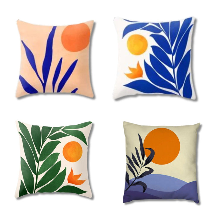 Four cream cushion covers with bold blue and green leaves, orange suns and abstract landscapes.