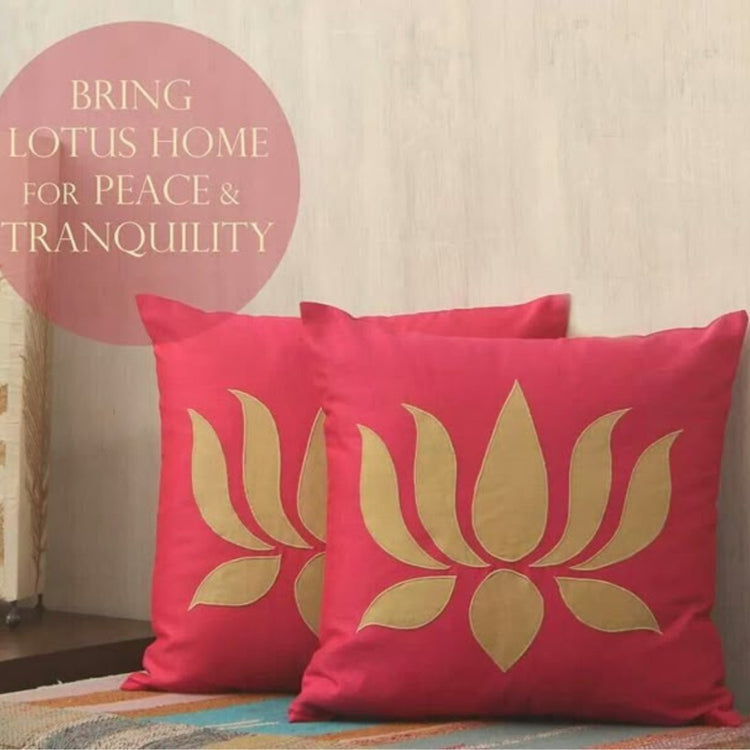 Pink cushion covers with gold coloured lotus motifs displayed in a styled room.