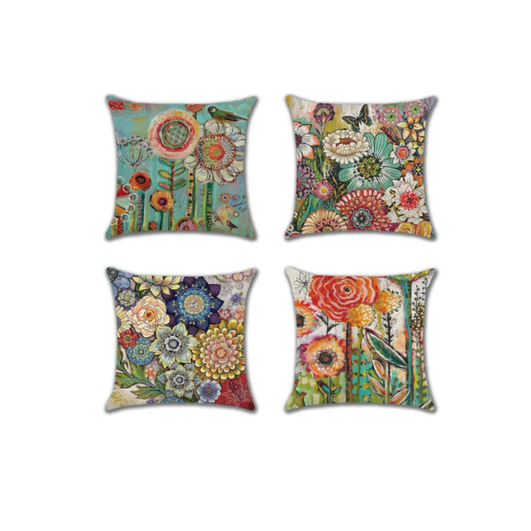 Four cushion covers with intricate colourful flower patterns.