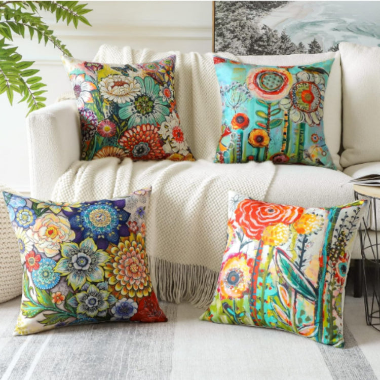 Four cushion covers with dense multicoloured floral prints displayed together.