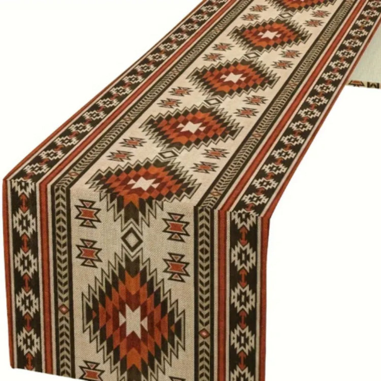 Close-up of the geometric diamond pattern and borders on a cream table runner.
