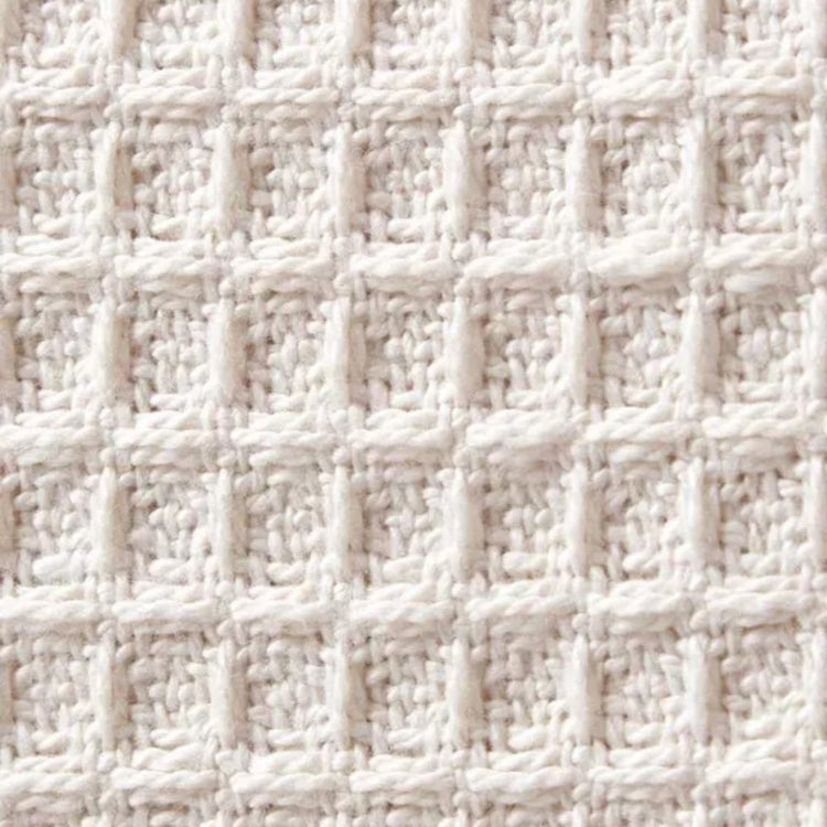 Close-up of a textured white fabric with a grid pattern