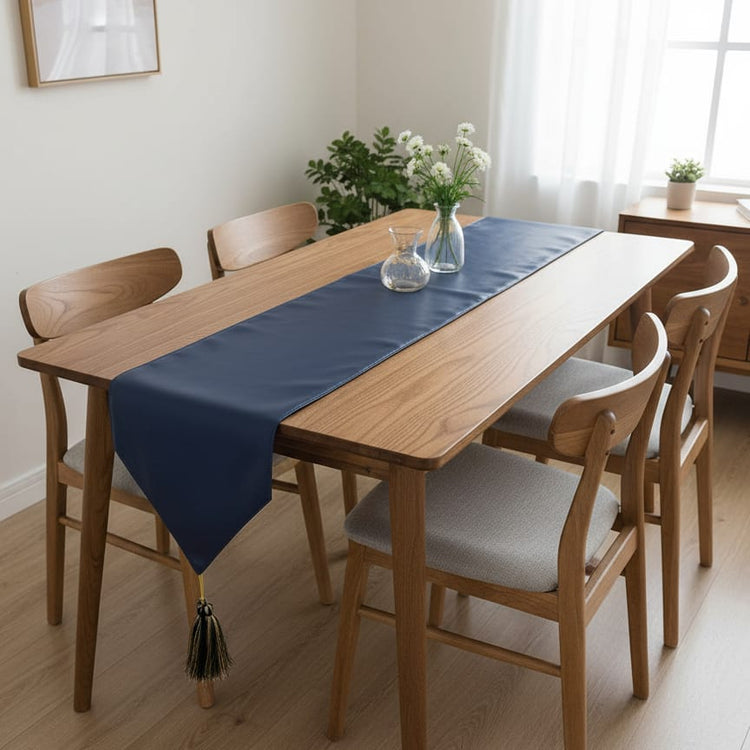 Plain navy table runner on a wooden dining table.
