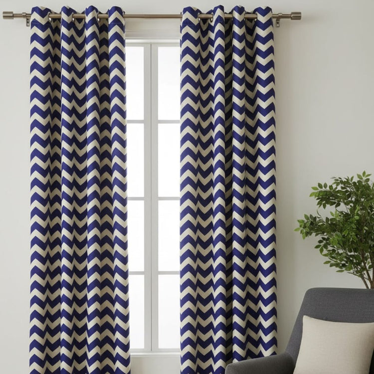 Navy and white chevron eyelet curtains hanging at a window.