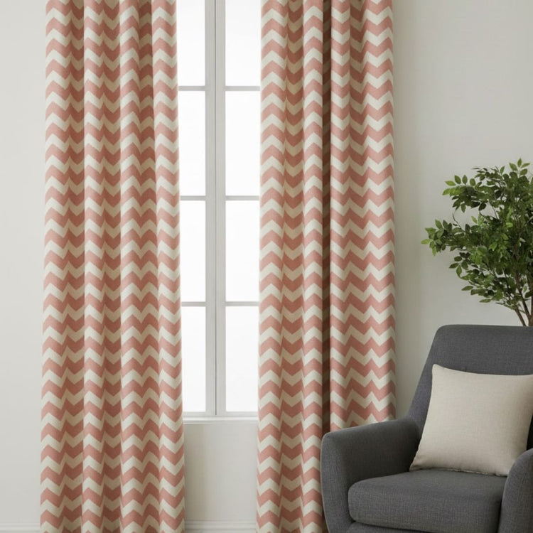 Terracotta and white chevron curtains hanging beside a window.
