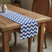 Blue and white chevron table runner on a wooden table.