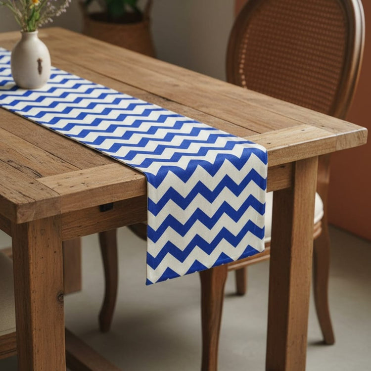 Blue and white chevron table runner on a wooden table.