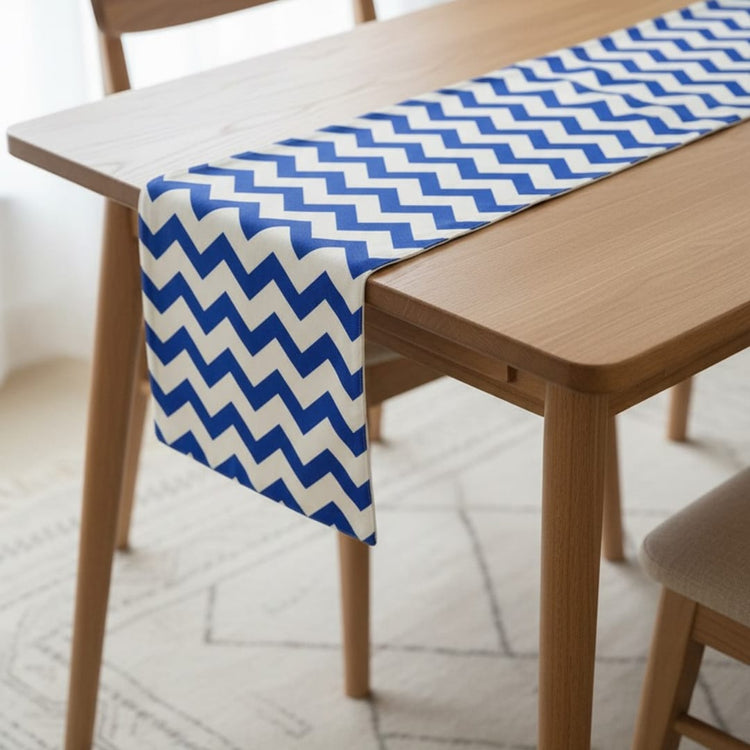 Blue and white chevron table runner draped over the end of a table.