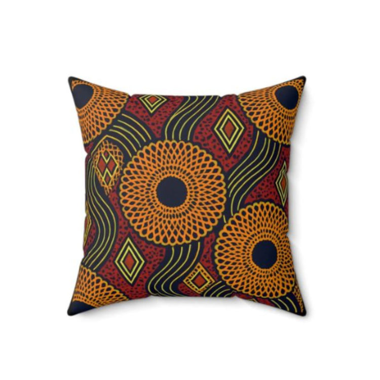 Cushion cover with dense orange, green, red and black circular and diamond patterns.