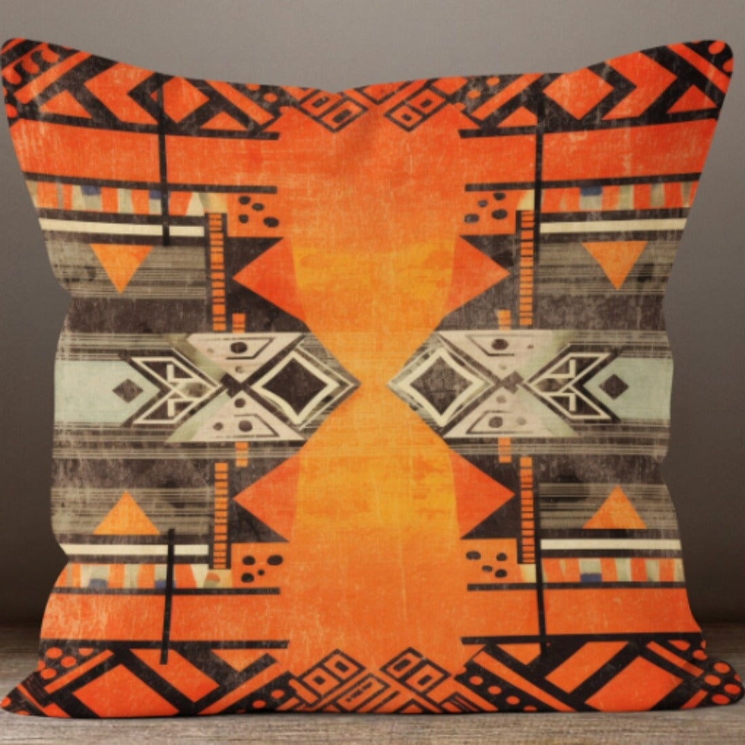 Cushion cover with a broad orange centre and grey and black geometric side patterns.