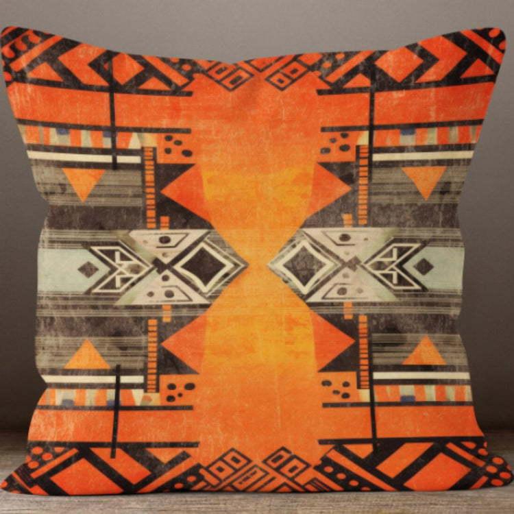 Cushion cover with a broad orange centre and grey and black geometric side patterns.