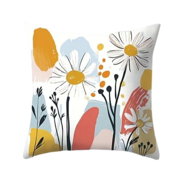 White cushion cover with large daisies over mustard, blue and coral abstract shapes.