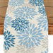 Cream table runner with light and dark blue floral motifs.