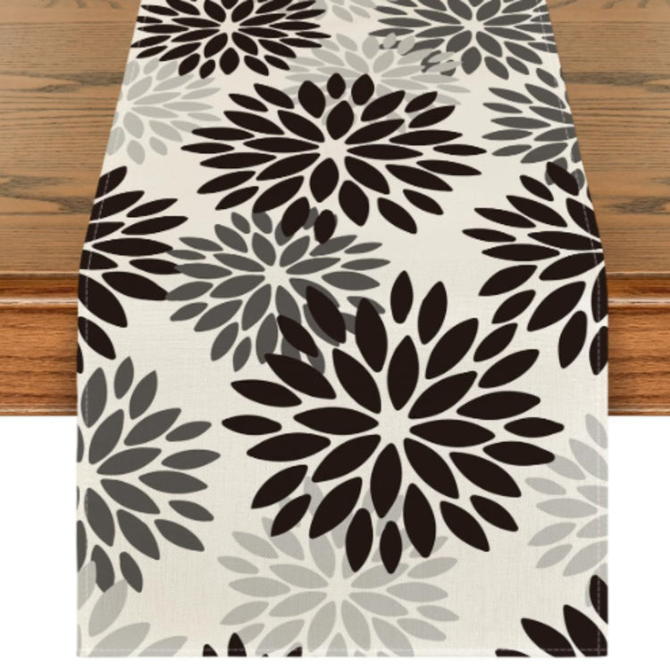 Cream table runner with black and grey large floral motifs.