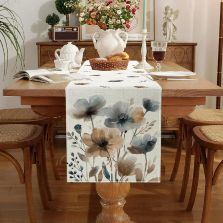 Blue and beige floral table runner displayed on a dining table.