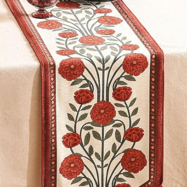 Cream table runner with red flowers, dark stems and red borders.
