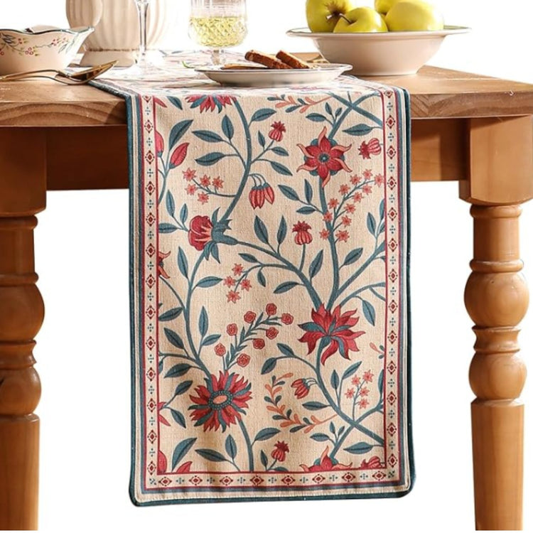 Cream table runner with red and blue botanical motifs and blue-red borders.