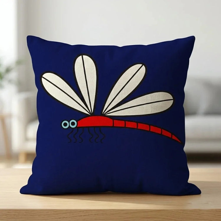 Navy cushion cover with a large cream-winged dragonfly and red body.