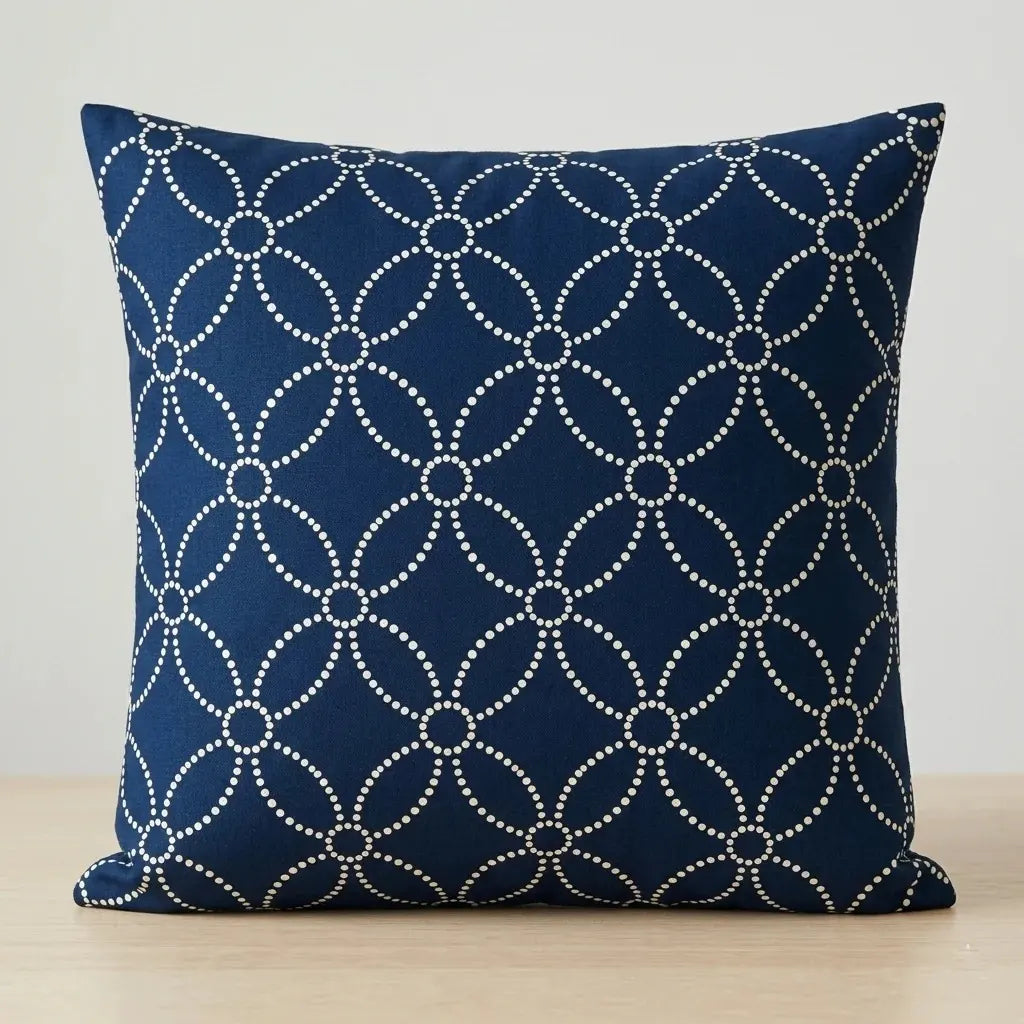Navy cushion cover with fine cream interlocking circles.