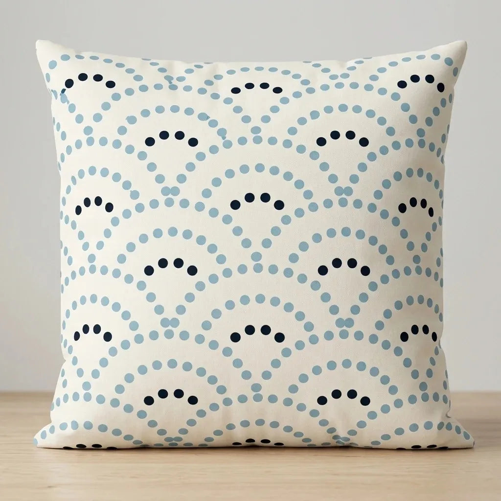 Cream cushion cover with pale blue and navy dotted fan patterns.