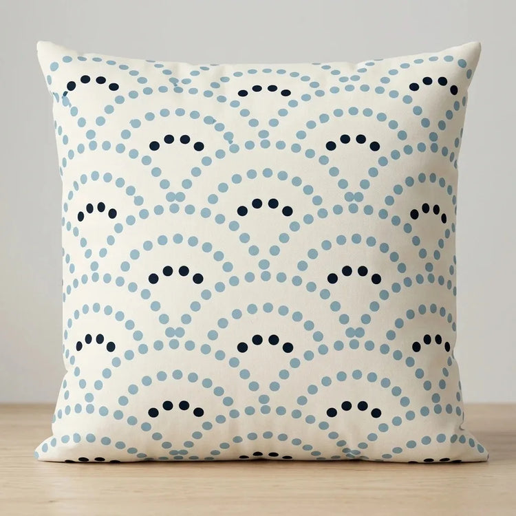 Cream cushion cover with pale blue and navy dotted fan patterns.