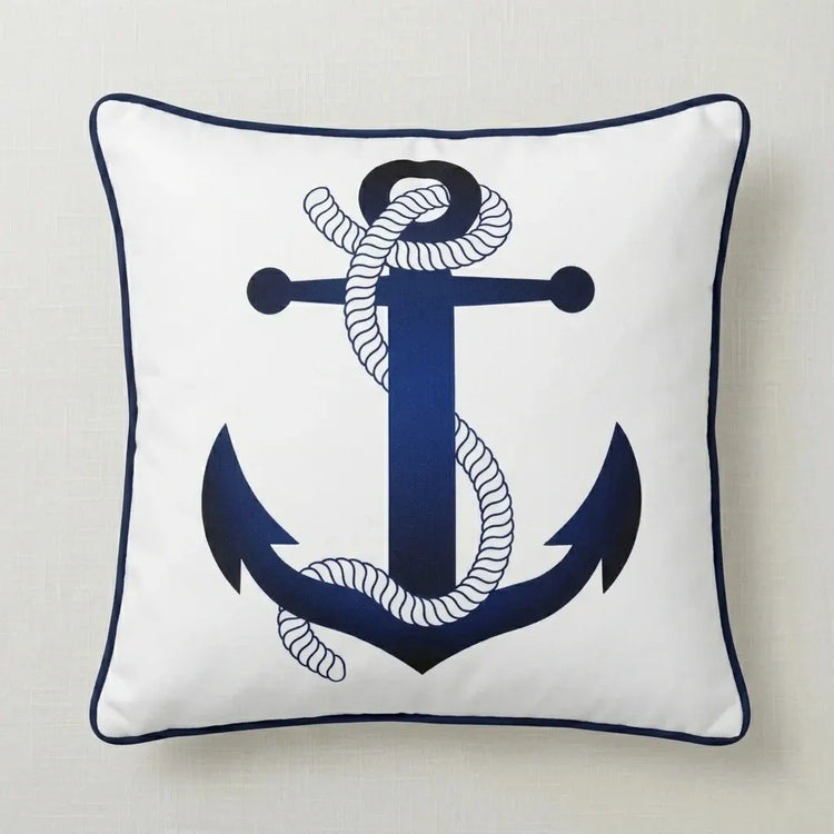 Cream cushion cover with a navy anchor and rope illustration and navy piping.