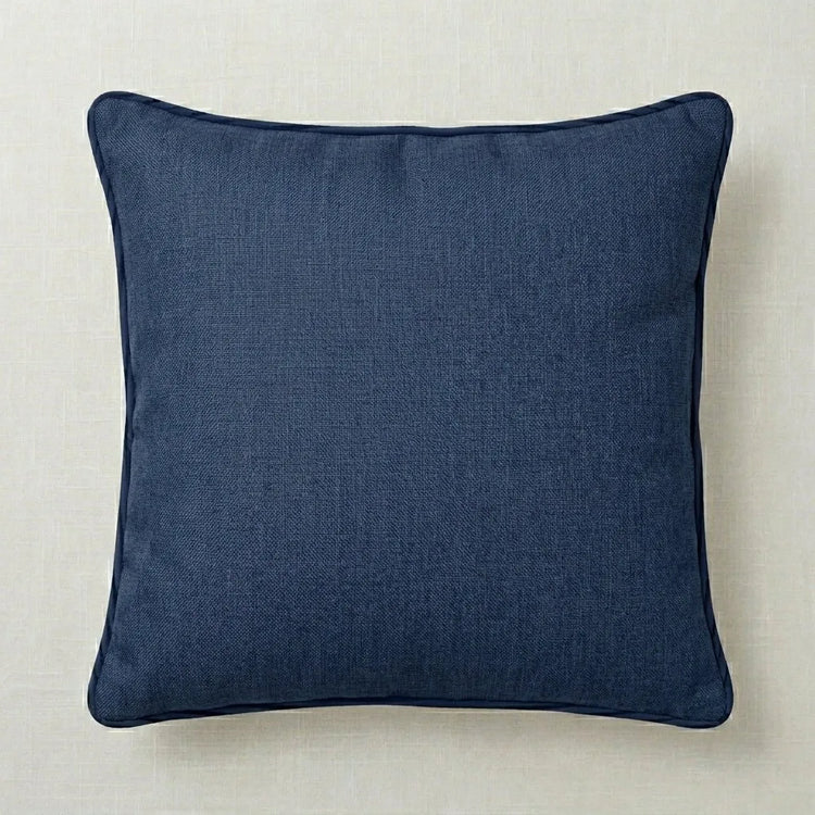 Plain navy cushion cover with dark piped edging.
