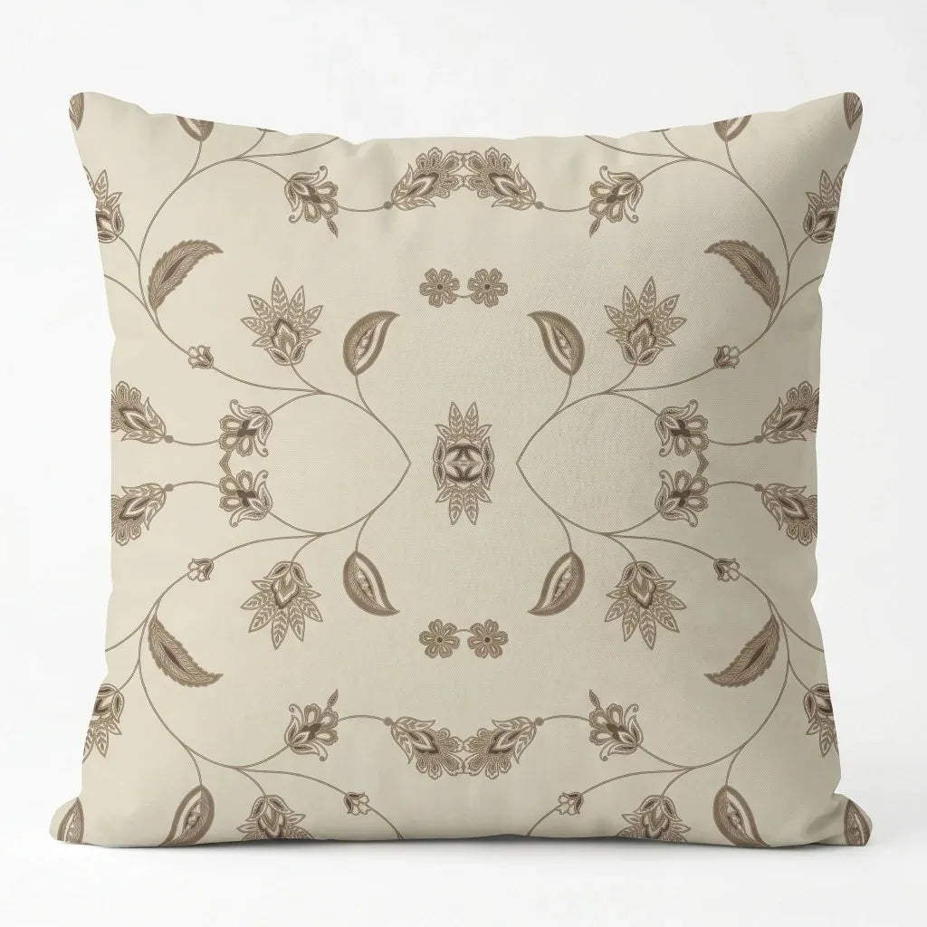 Cream cushion cover with delicate brown botanical drawings and looping decorative lines.