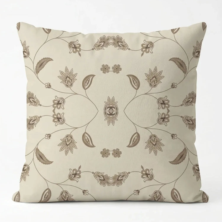 Cream cushion cover with delicate brown botanical drawings and looping decorative lines.