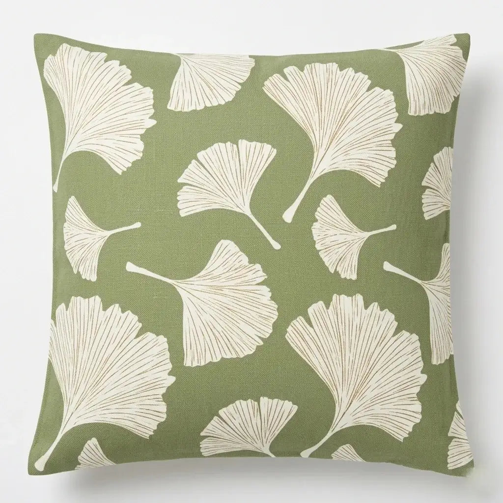 Sage green cushion cover with cream fan-shaped ginkgo leaves.