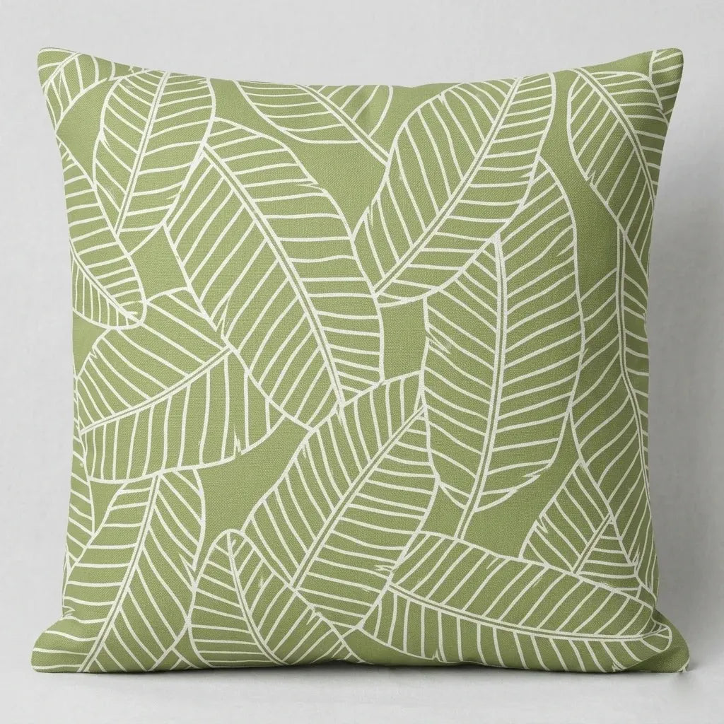 Sage green cushion cover with fine white banana leaf outlines.