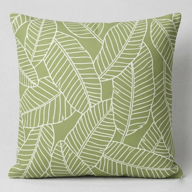Sage green cushion cover with fine white banana leaf outlines.
