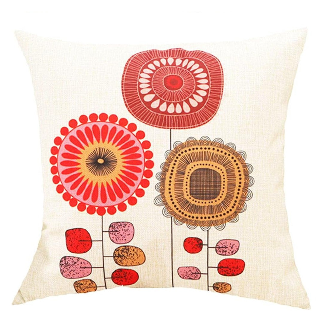 Cream cushion cover with red, orange and brown circular flowers on slender stems.