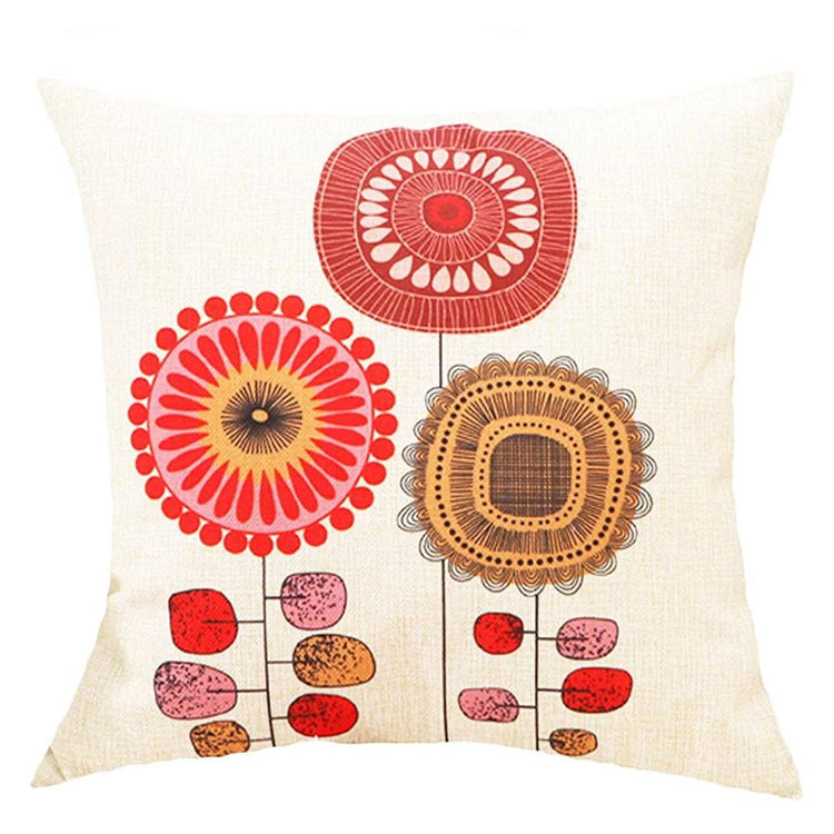 Cream cushion cover with red, orange and brown circular flowers on slender stems.