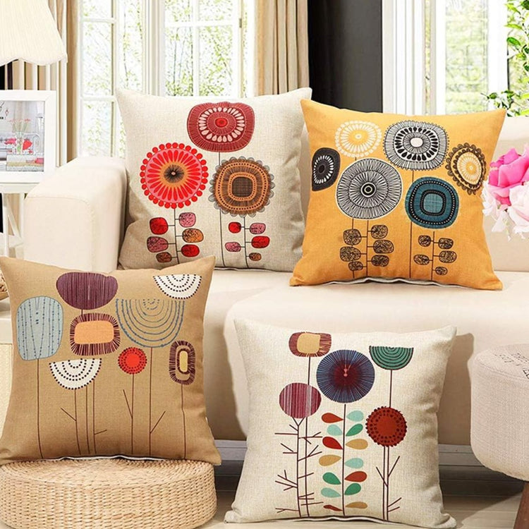 Four cream and mustard cushion covers with stylised circular flower designs.