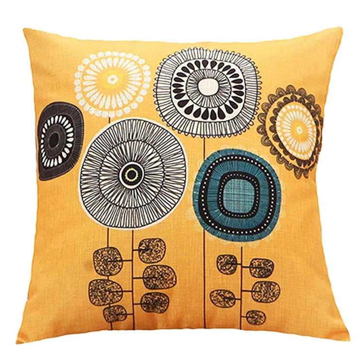 Mustard cushion cover with large grey, blue and brown circular flowers.
