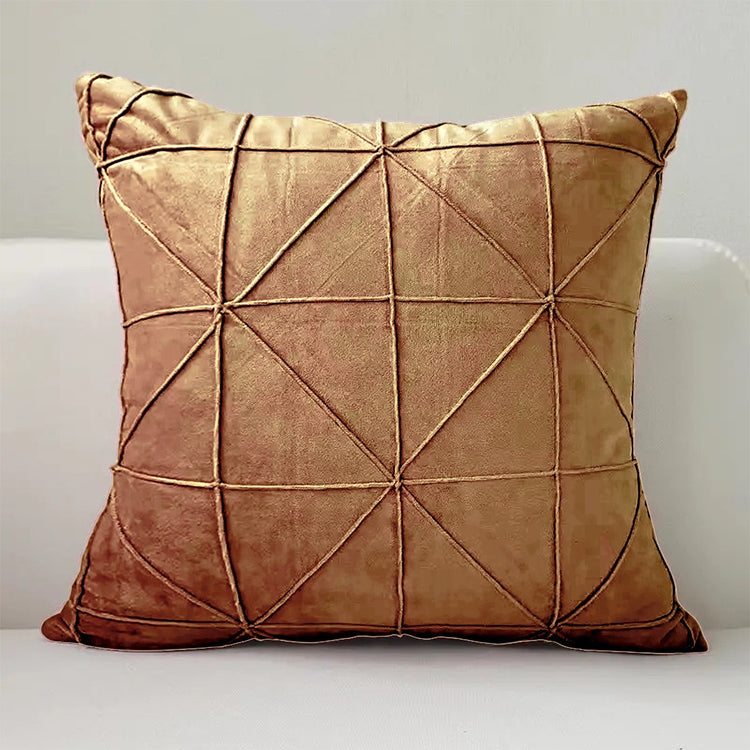 Tan cushion cover with intersecting geometric stitched lines.