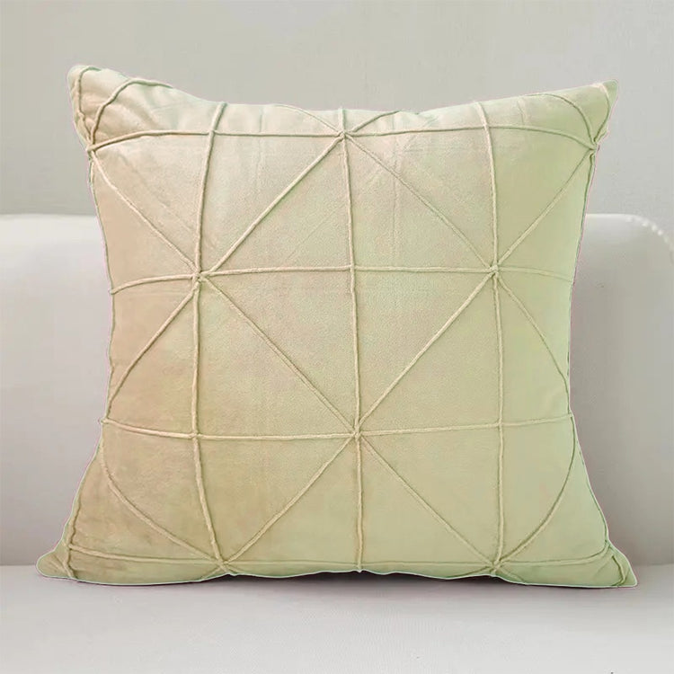 Cream cushion cover with intersecting geometric stitched lines.